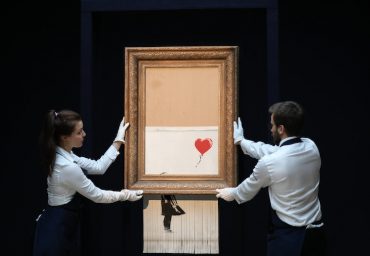 LONDON, ENGLAND - OCTOBER 12: Sotheby‚Äôs unveils Banksy‚Äôs newly-titled ‚ÄòLove is in the Bin‚Äô at Sotheby's on October 12, 2018 in London, England. Originally titled ‚ÄòGirl with Balloon‚Äô, the canvas passed through a hidden shredder seconds after the hammer fell at Sotheby‚Äôs London Contemporary Art Evening Sale on October 5, 2018, making it the first artwork in history to have been created live during an auction. (Photo by Tristan Fewings/Getty Images for Sotheby's)